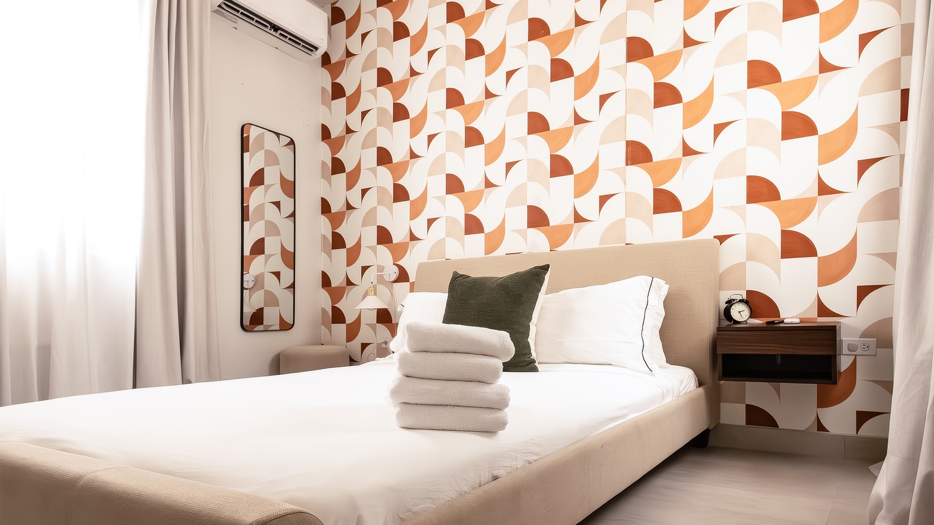 a bed with towels stacked on top of it