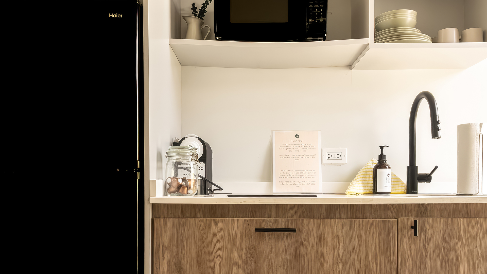a kitchen counter with a microwave and a glass jar