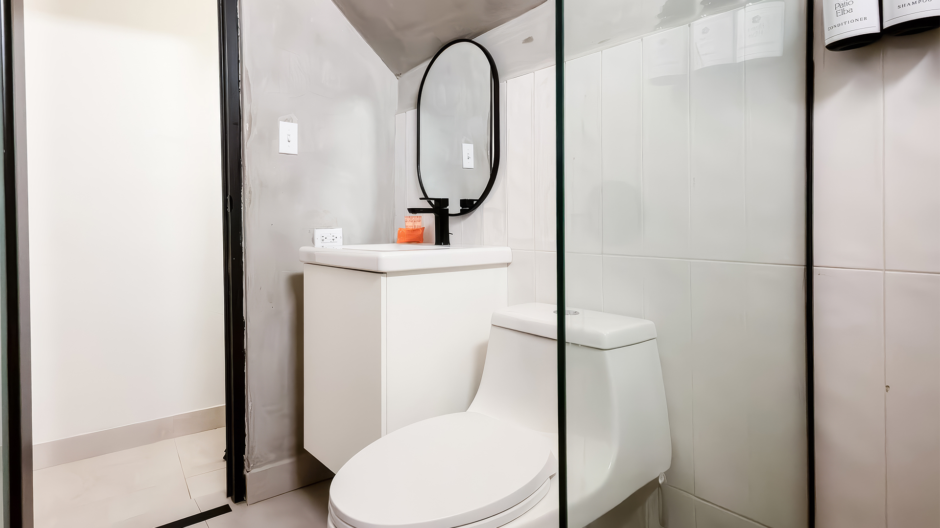 a bathroom with a glass shower door