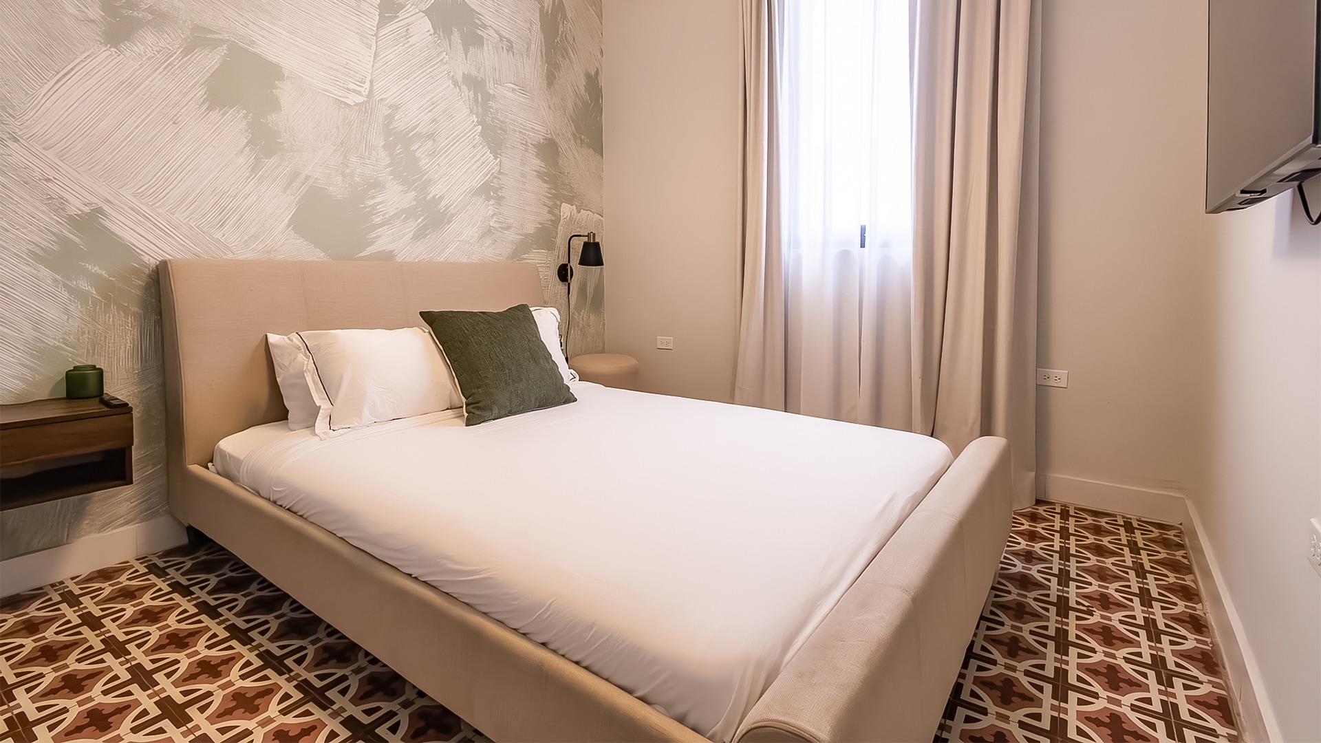 a bed with pillows and a lamp in a room