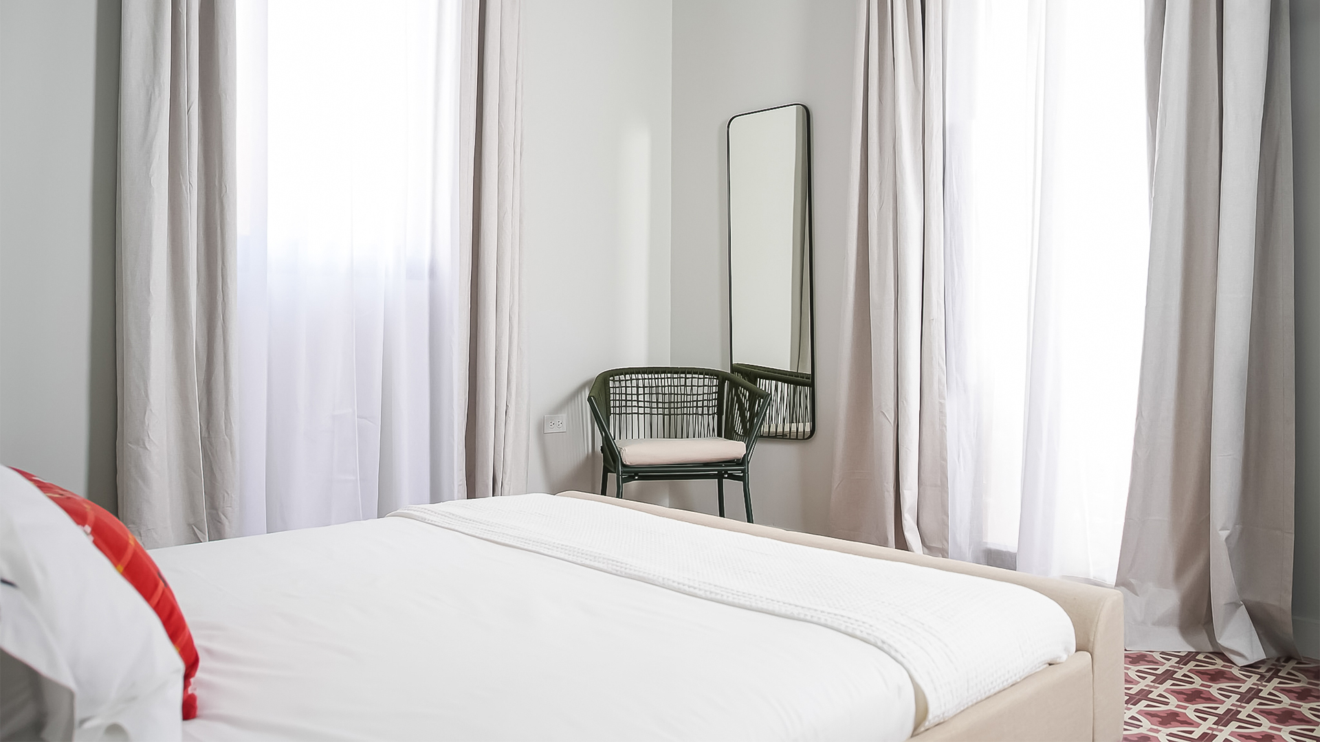 a chair next to a bed