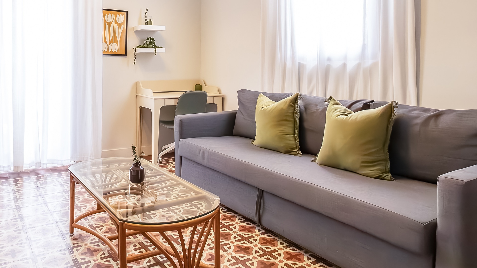 a couch with green pillows in a room