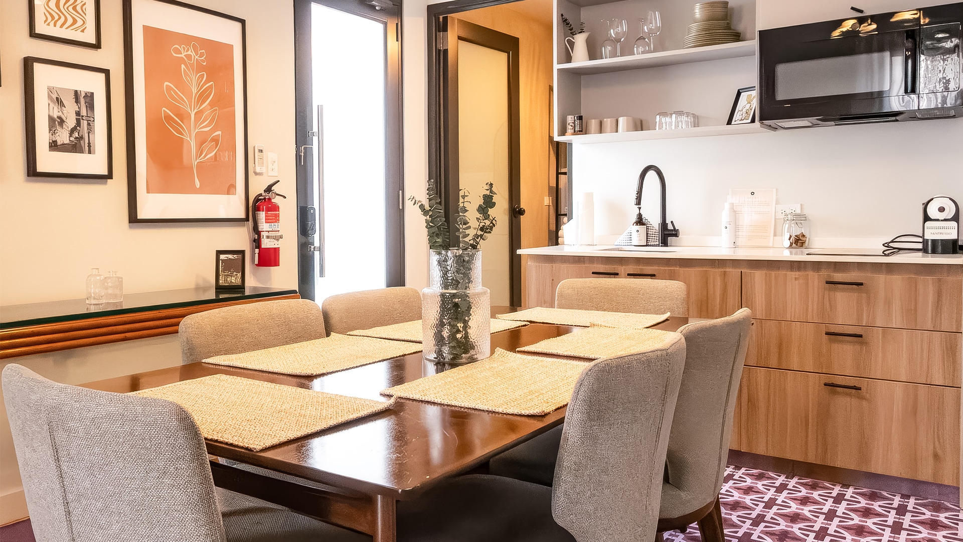 a dining table with chairs and a plant on it