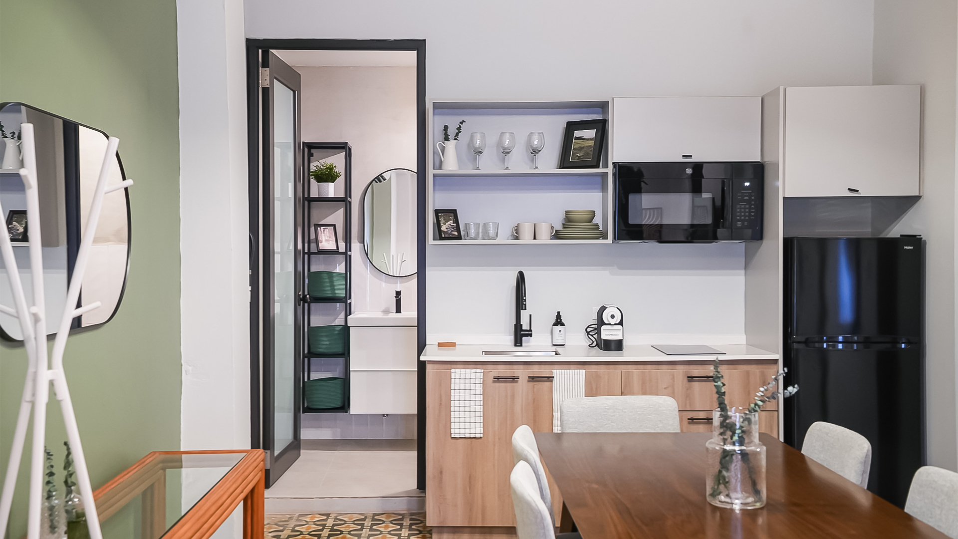 a kitchen with a table and a microwave