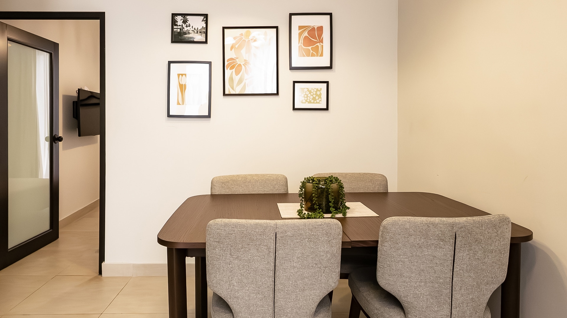 a dining table with chairs and a vase on the table