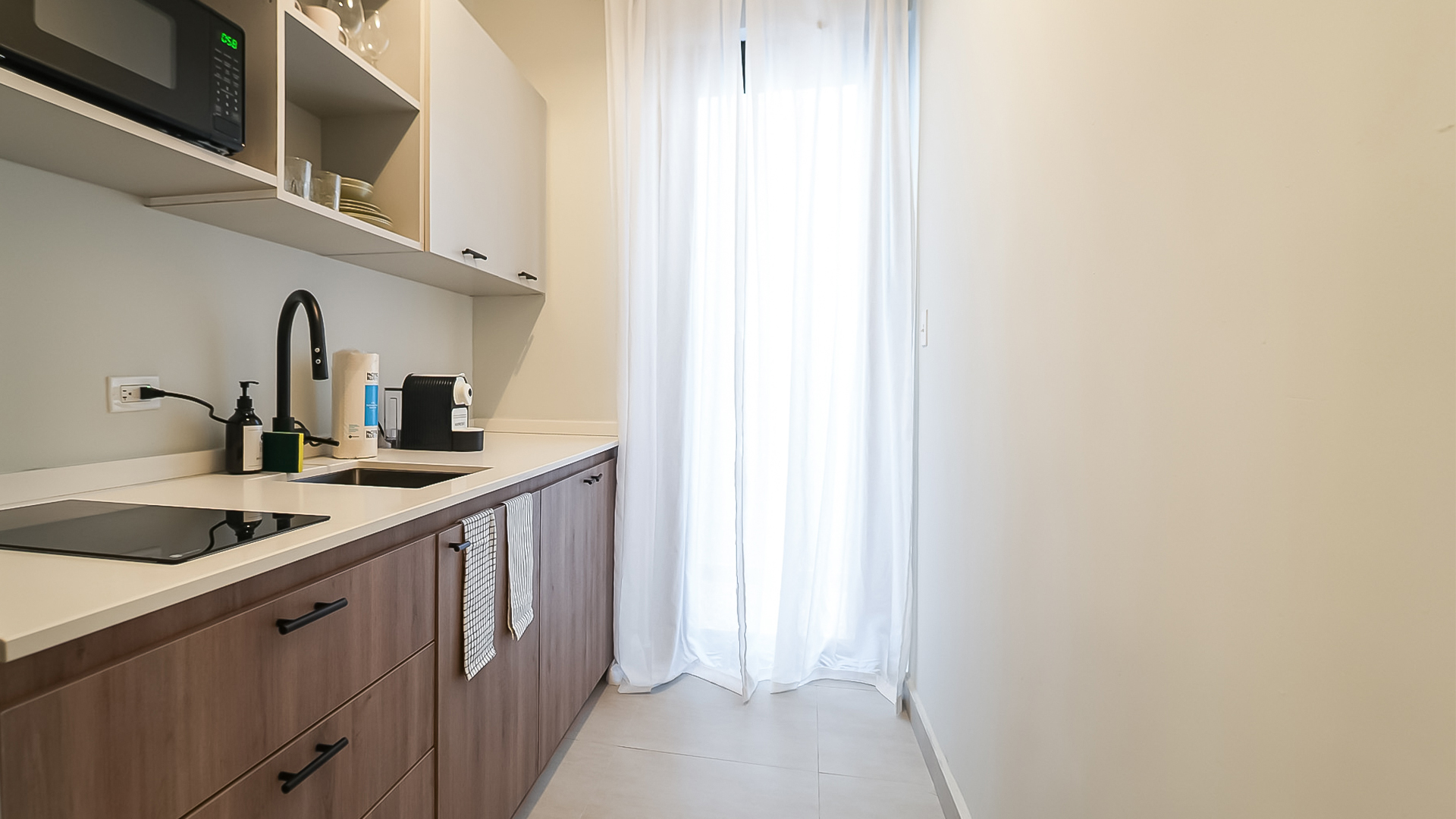 a kitchen with white curtains