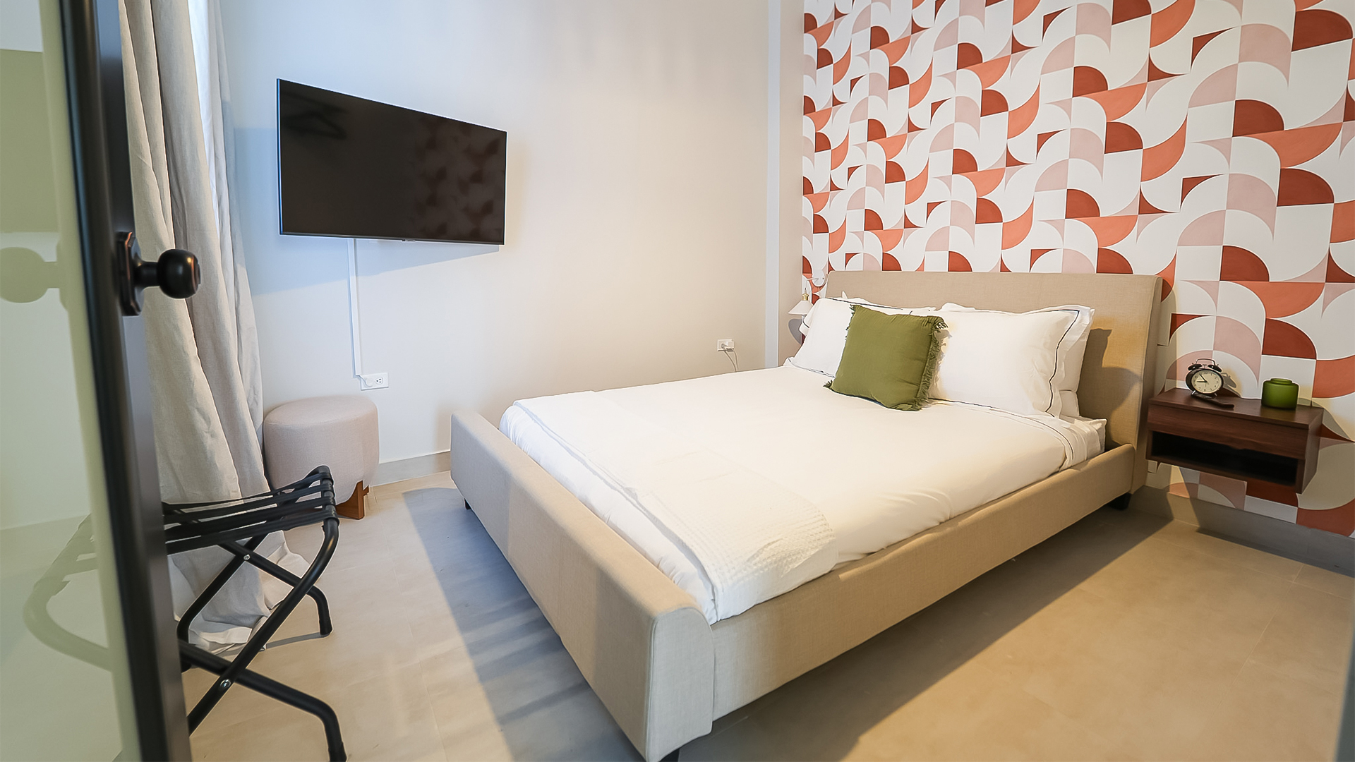 a Cozy bedroom with wall-mounted TV