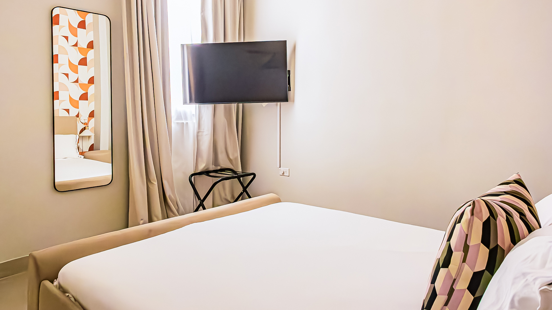 a bed with a tv mounted on the wall