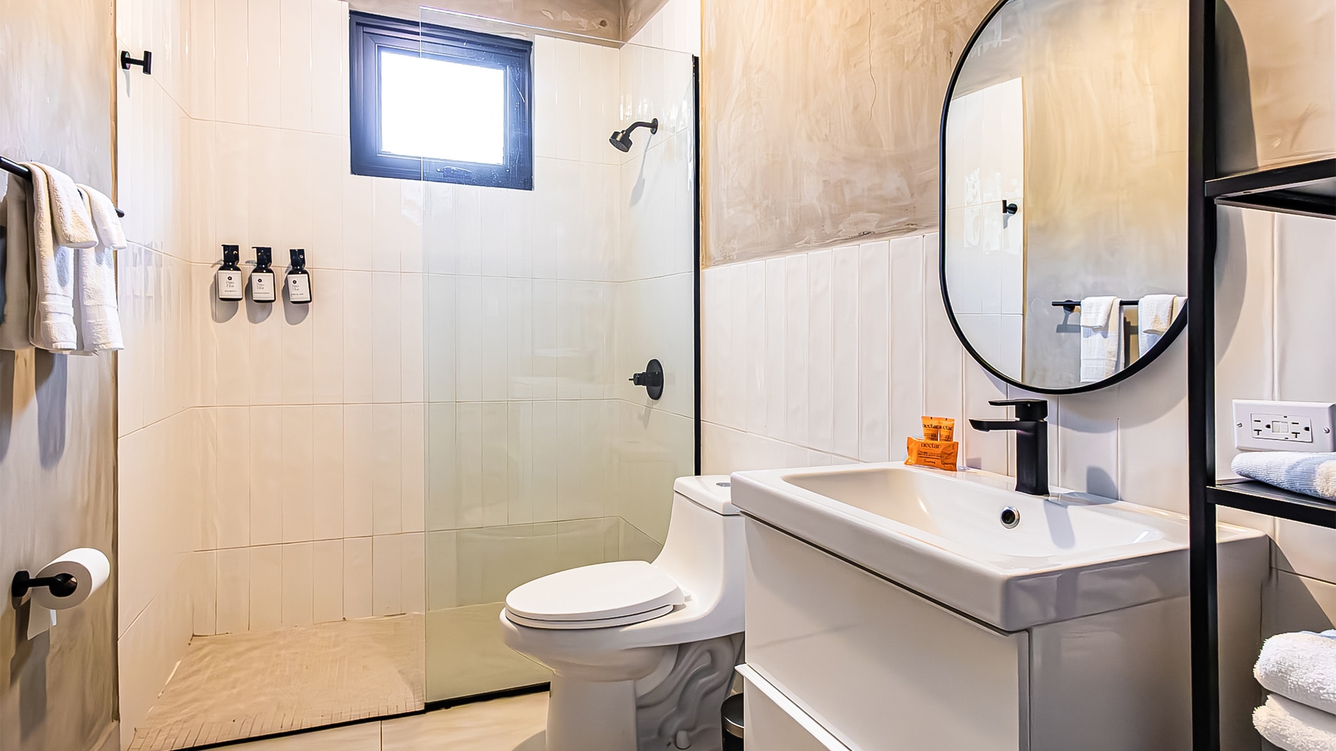 Bright bathroom with round mirror