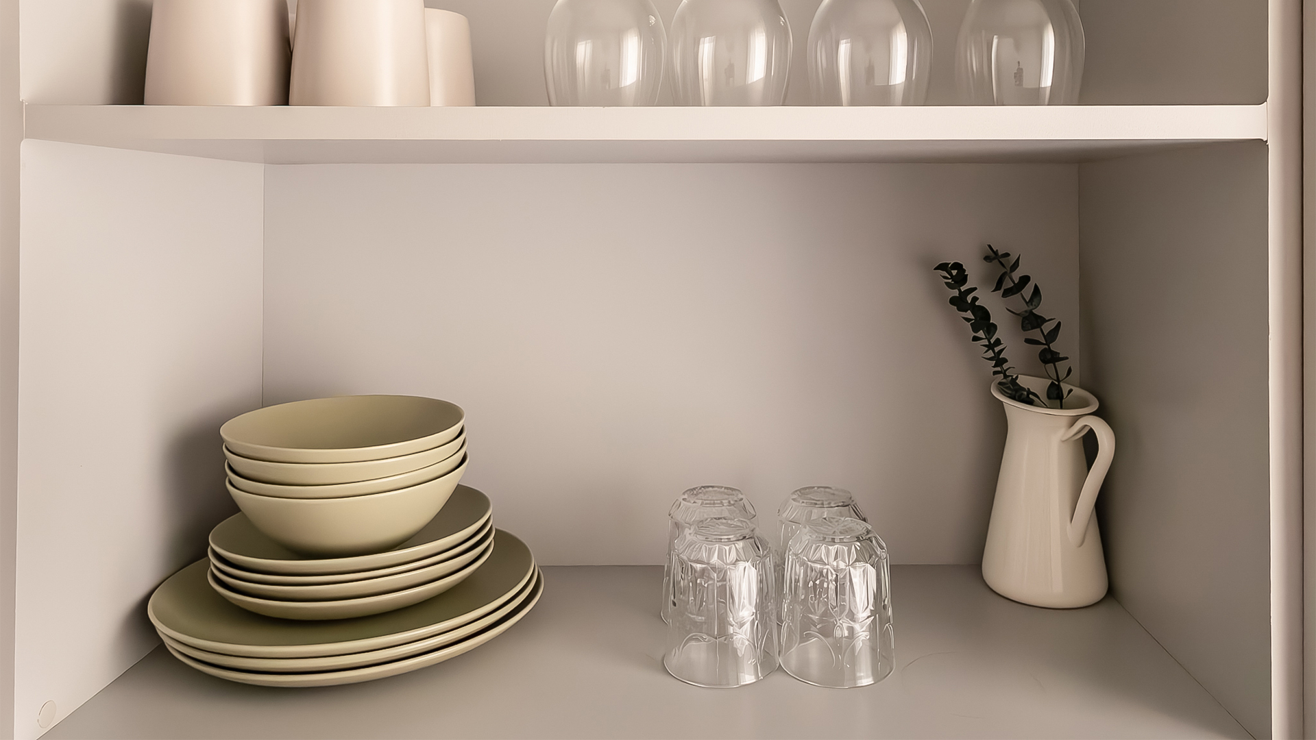 a shelf with plates and glasses