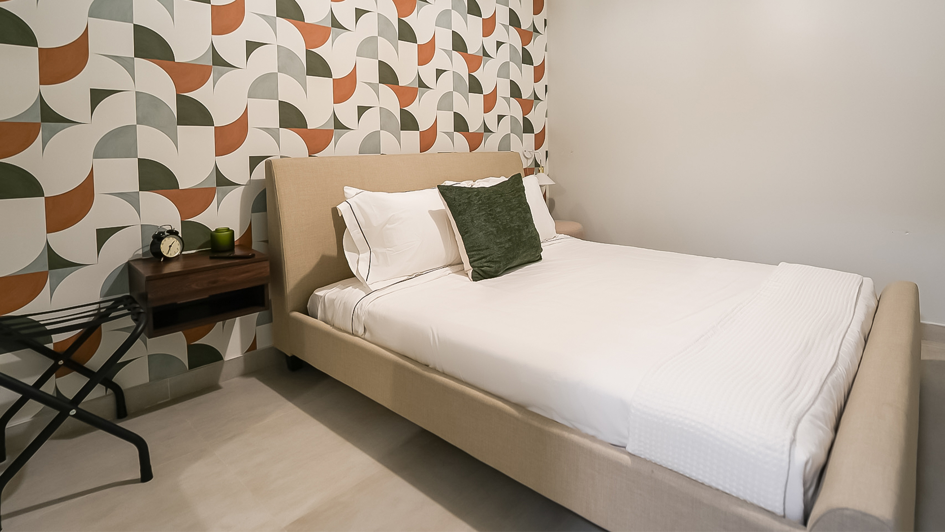 a bed with a green pillow