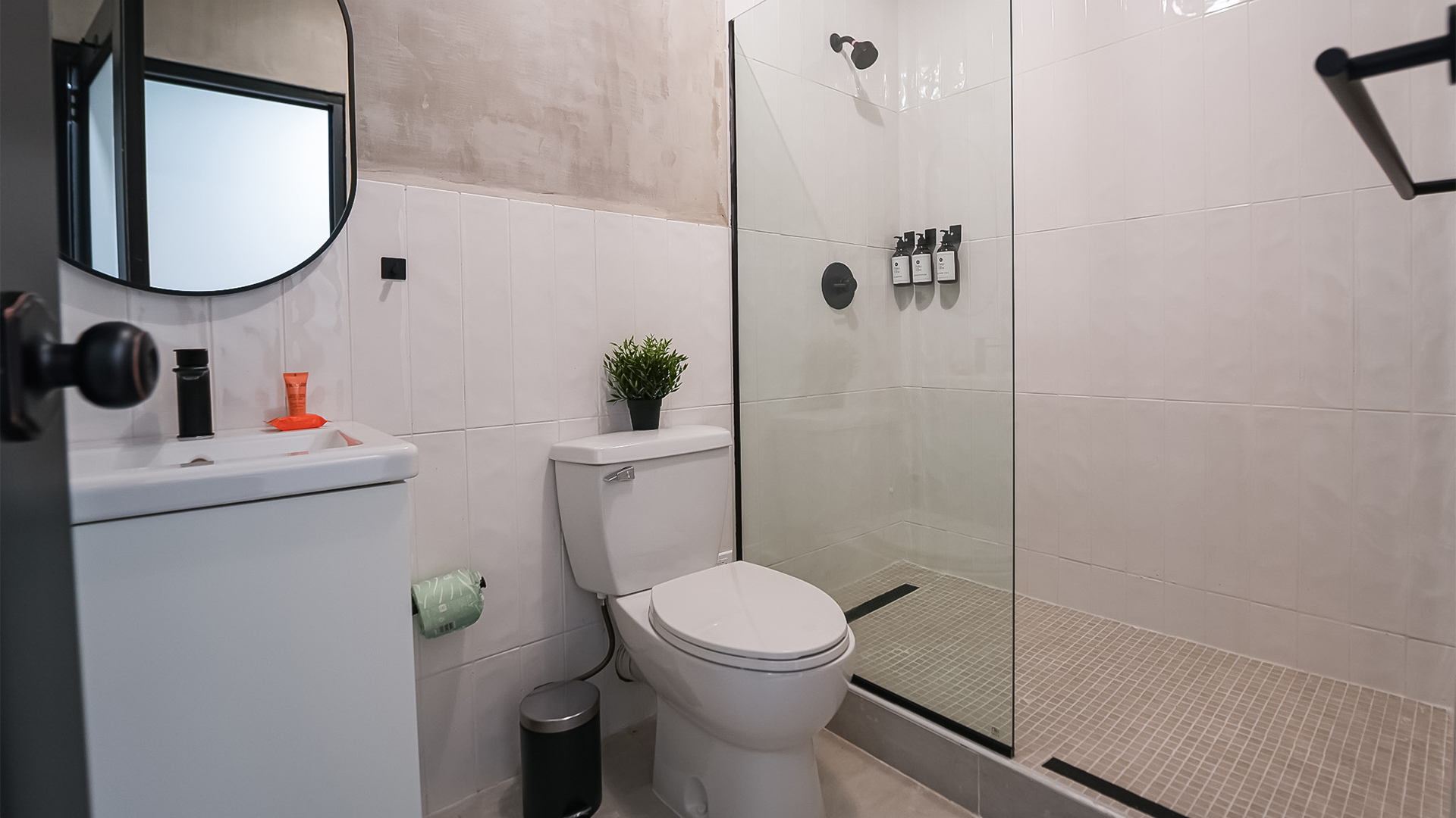 a bathroom with a glass shower and toilet
