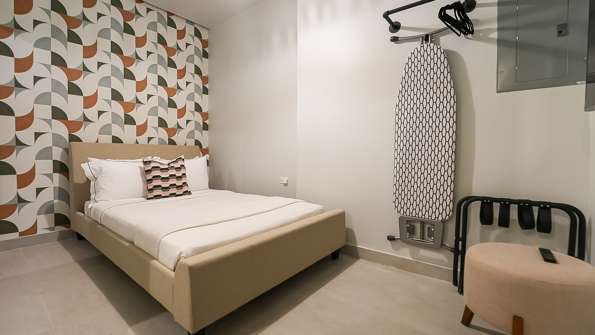 a bed with a surfboard on a rack