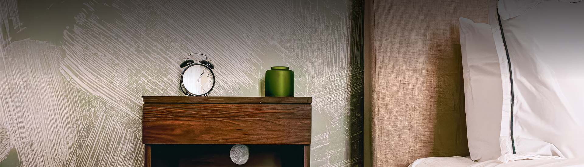 a green vase on a shelf