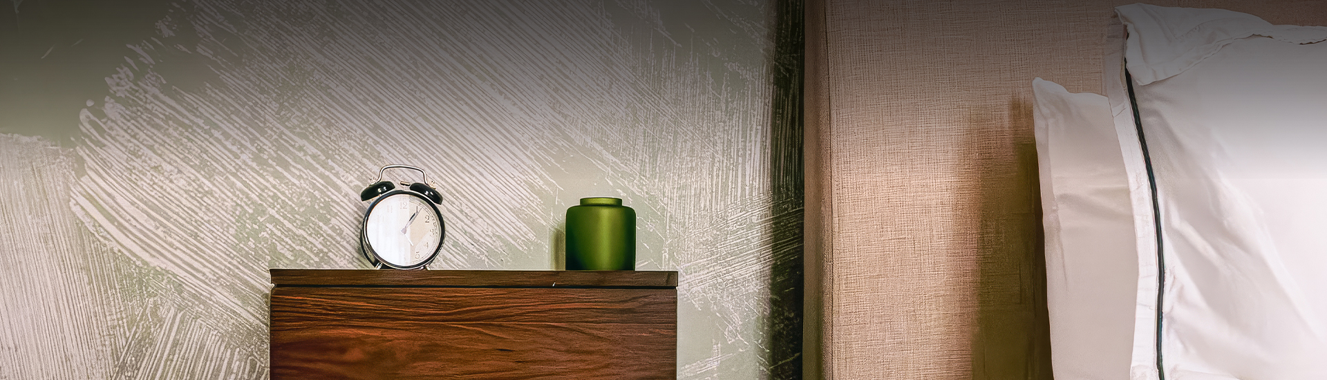 a green vase on a wooden surface