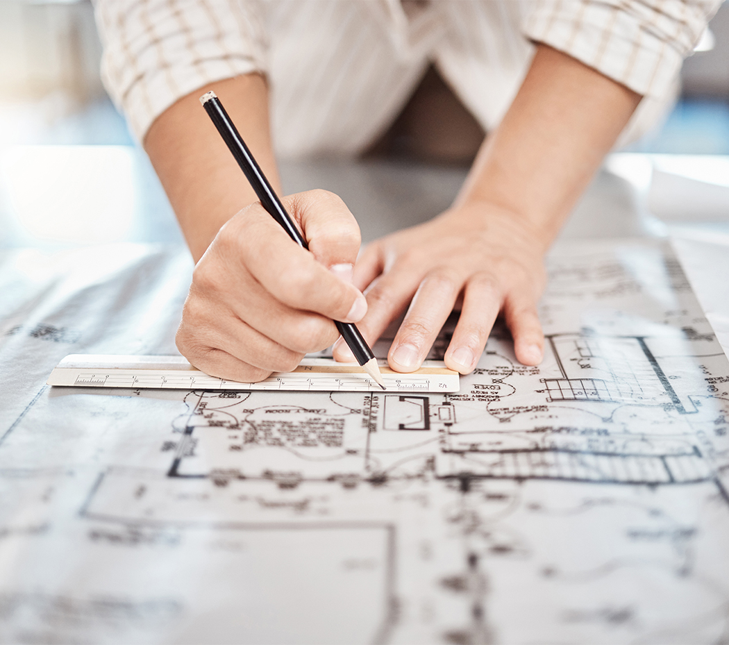 a person drawing on a ruler