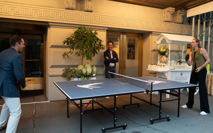 a man standing in front of a ping pong table