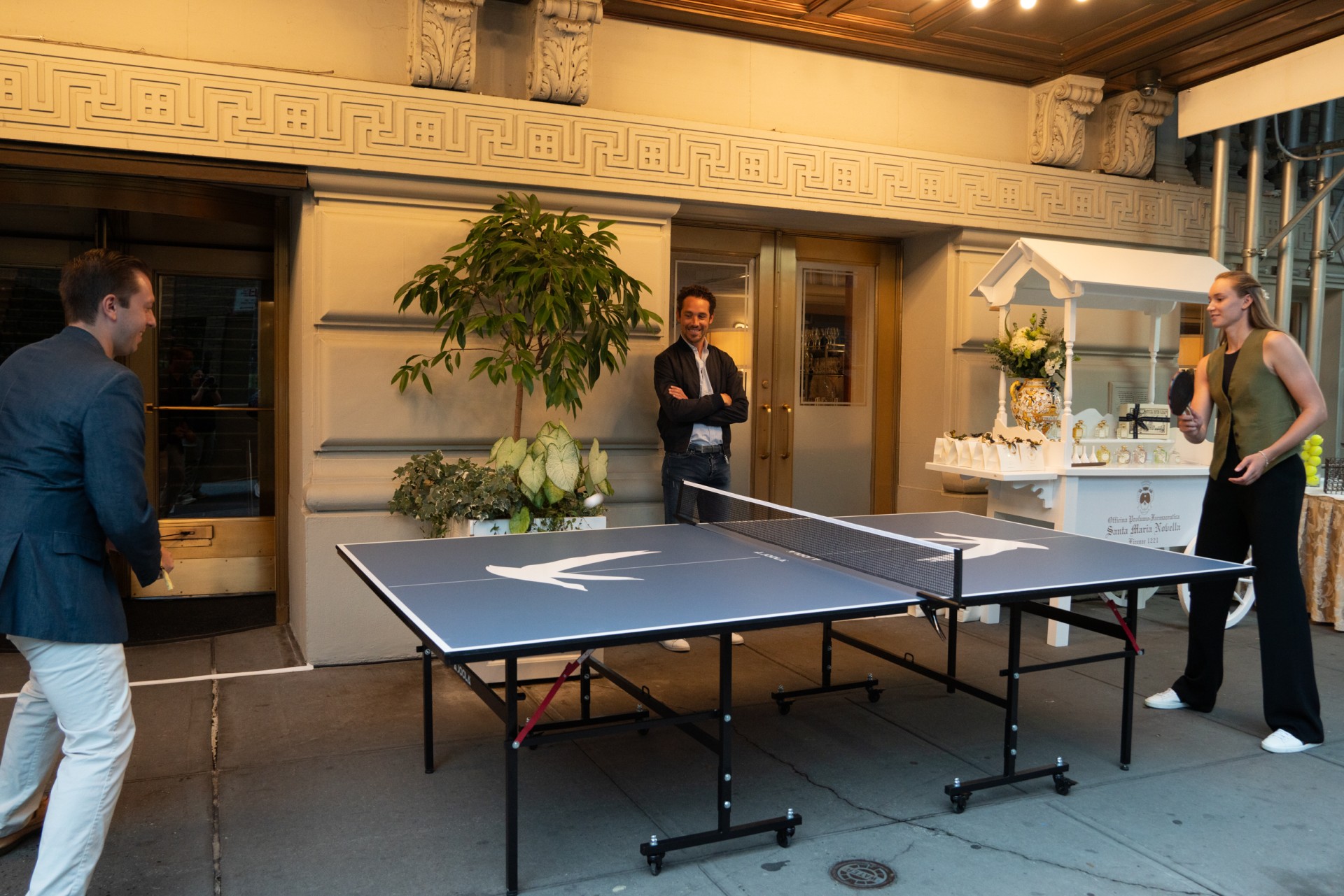 a man standing in front of a ping pong table