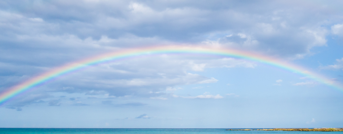 a rainbow over a body of water