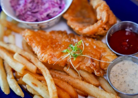 a plate of food with sauces and dipping sauces
