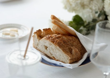 a plate of bread and a drink on a table