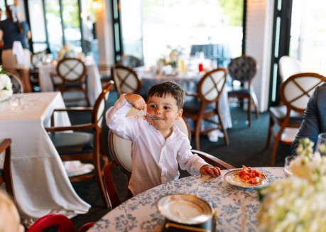 a boy eating at a table