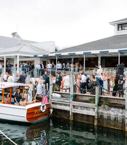 a group of people standing around a boat