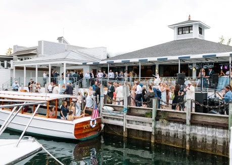 a group of people standing around a boat