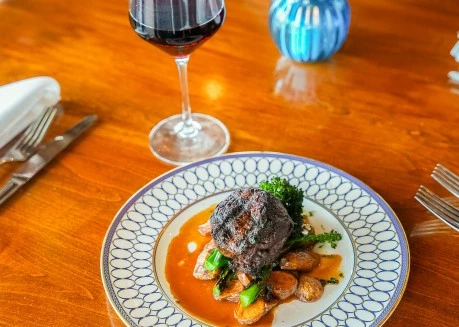 a plate of food and a glass of wine