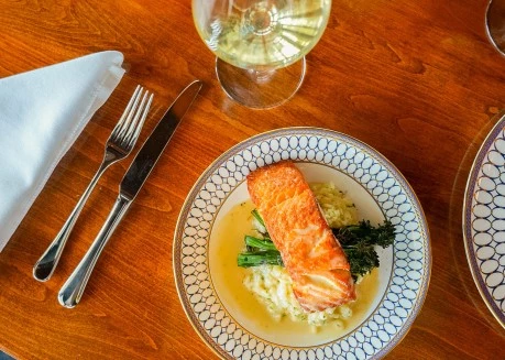 a plate of food and a glass of wine