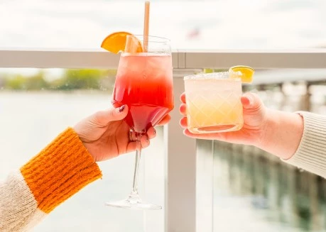 a pair of hands holding drinks