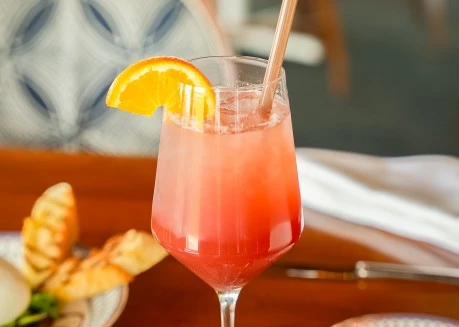 a glass with a drink and a straw