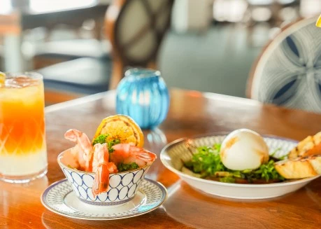 a bowl of shrimp and salad on a table