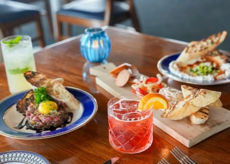 a table with plates of food and a drink