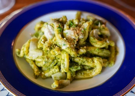 a plate of pasta with pesto sauce