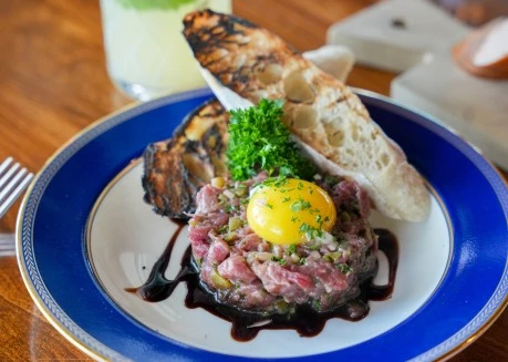 a plate of food with a glass of juice