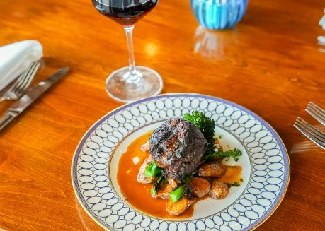 a plate of food and a glass of wine