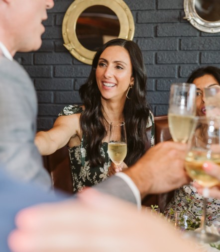a group of people holding wine glasses