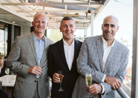 a group of men holding drinks