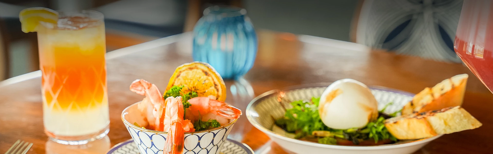 a bowl of shrimp and salad on a table