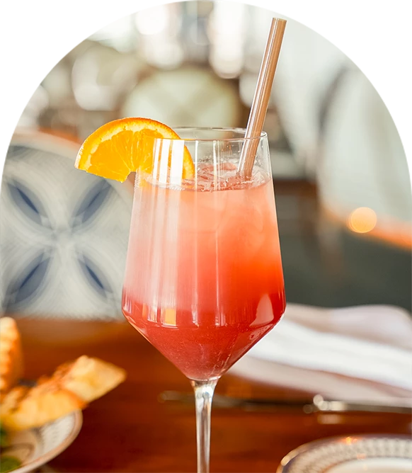 a glass with a drink and a straw