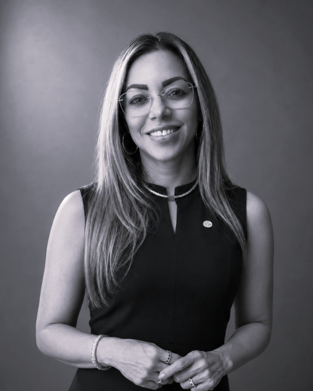 a woman wearing glasses and a black dress