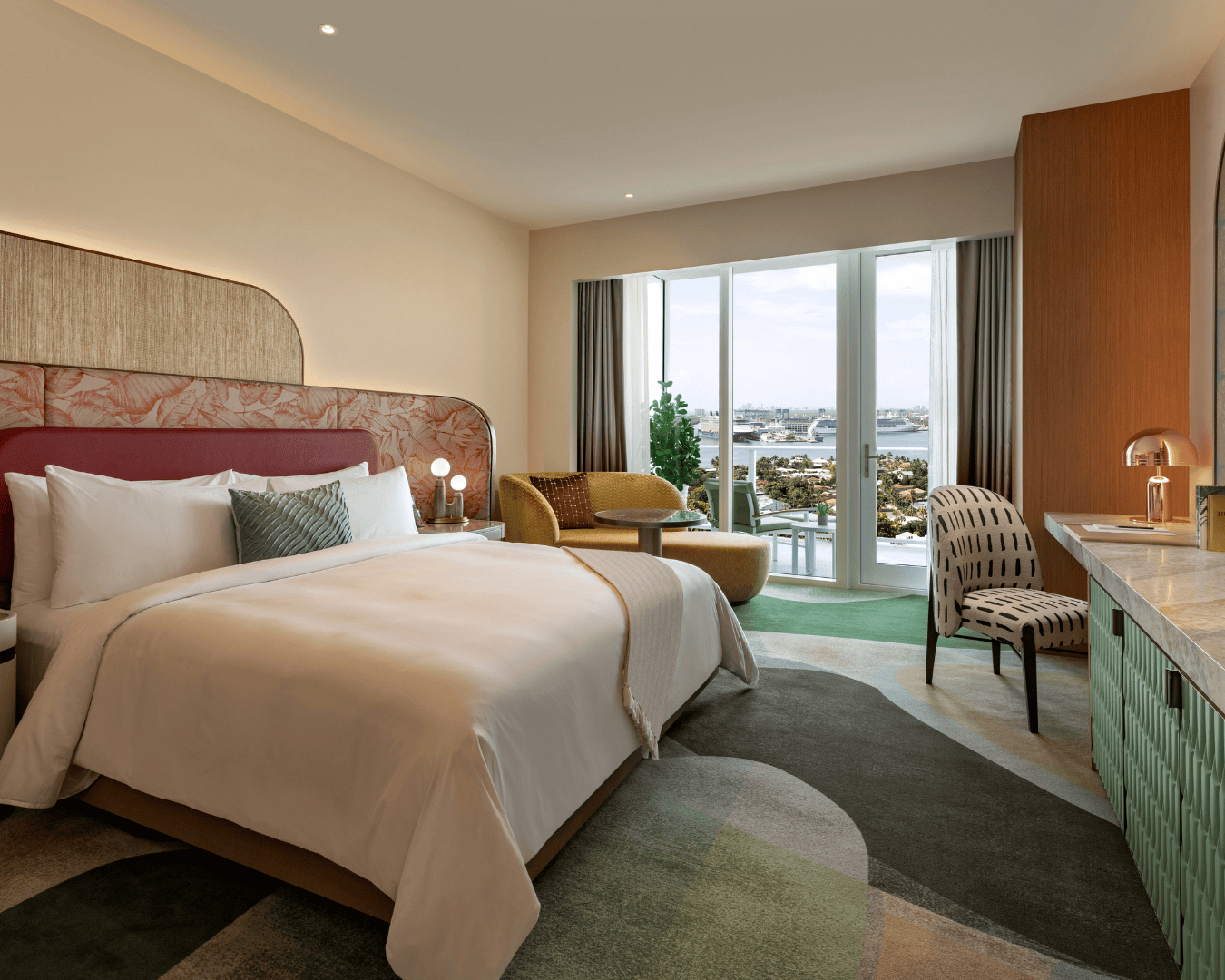 a room with a bed and chairs and a table