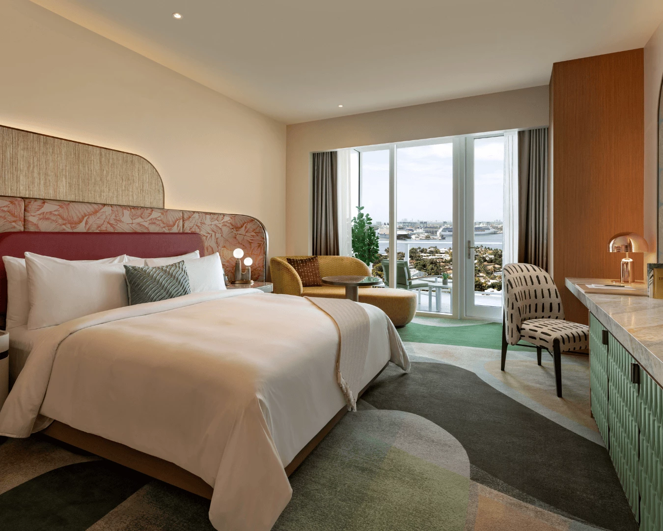 a room with a bed and chairs and a table