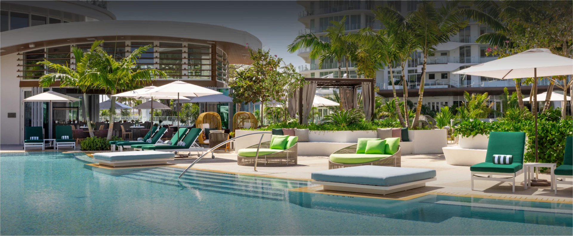 a pool with lounge chairs and umbrellas