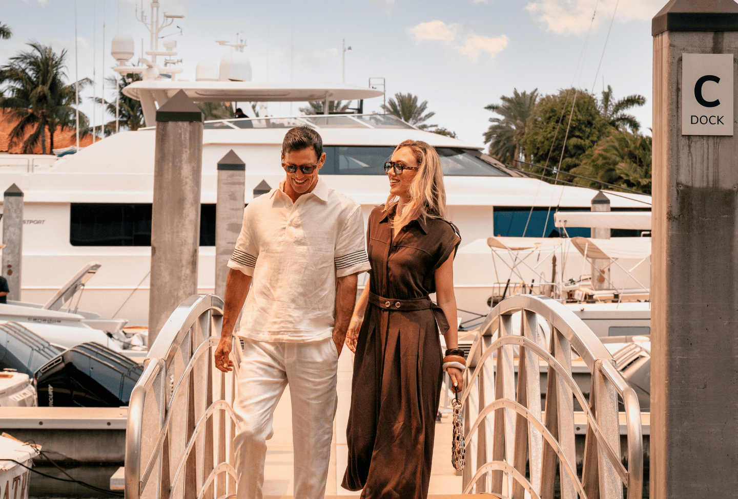 a man and woman walking on a marina