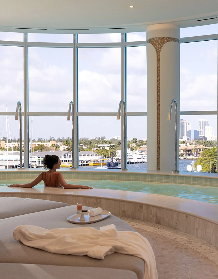 a woman in a pool with a view of the city