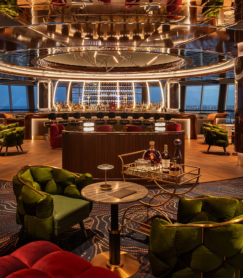 a room with a bar and chairs