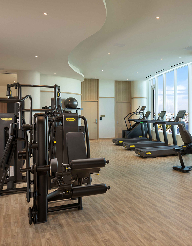 a room with exercise equipment and a large window