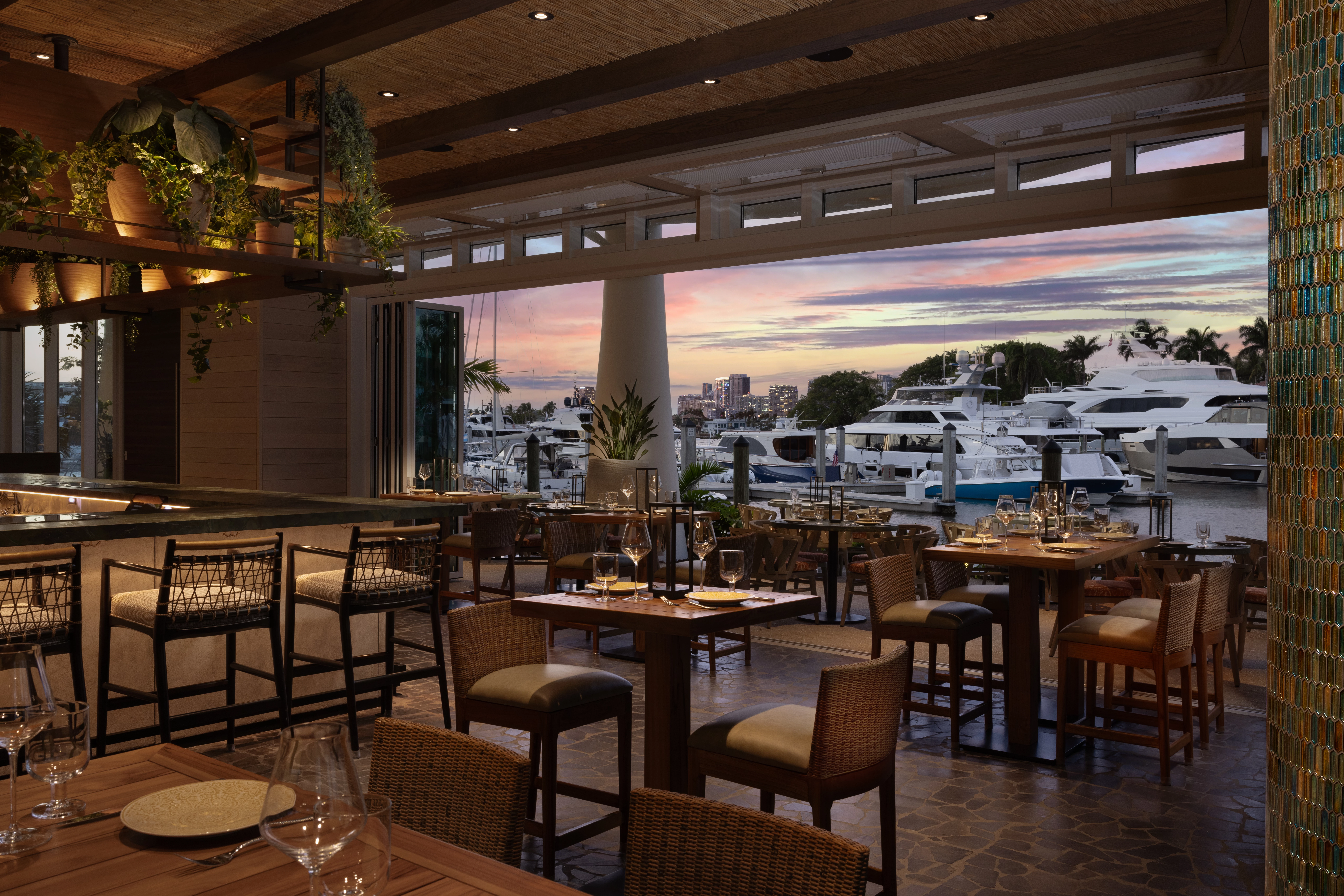 a restaurant with tables and chairs and a view of the marina